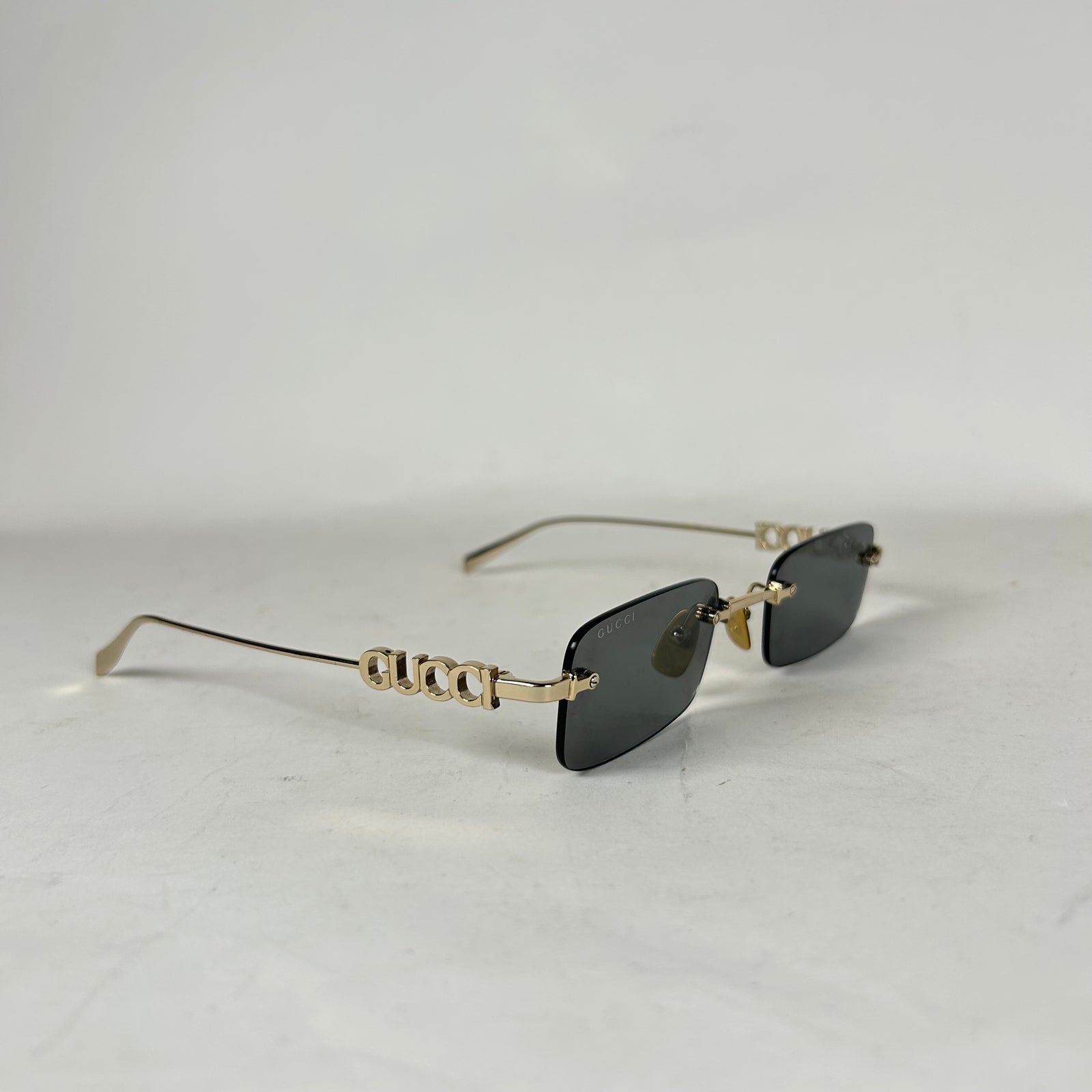 Gucci Spellout Logo Rimless Sunglasses