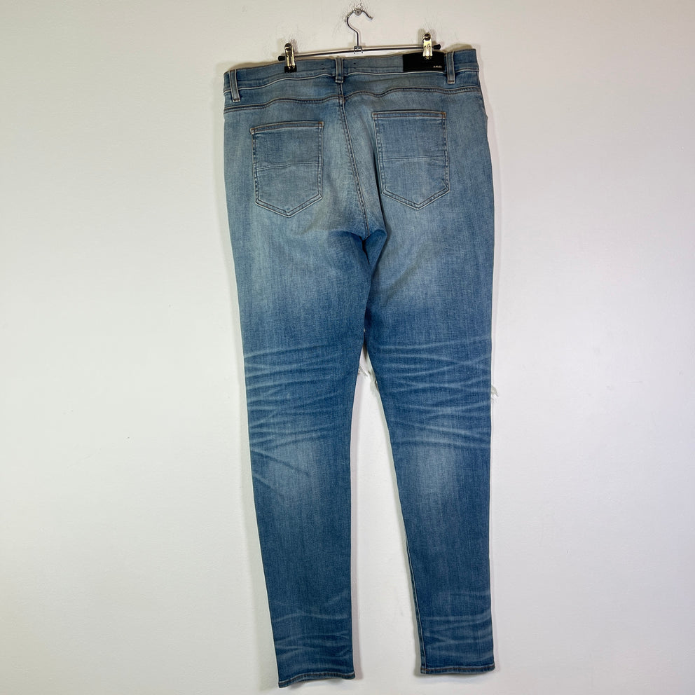 Amiri Lightwash Denim Patch Distressed Jeans