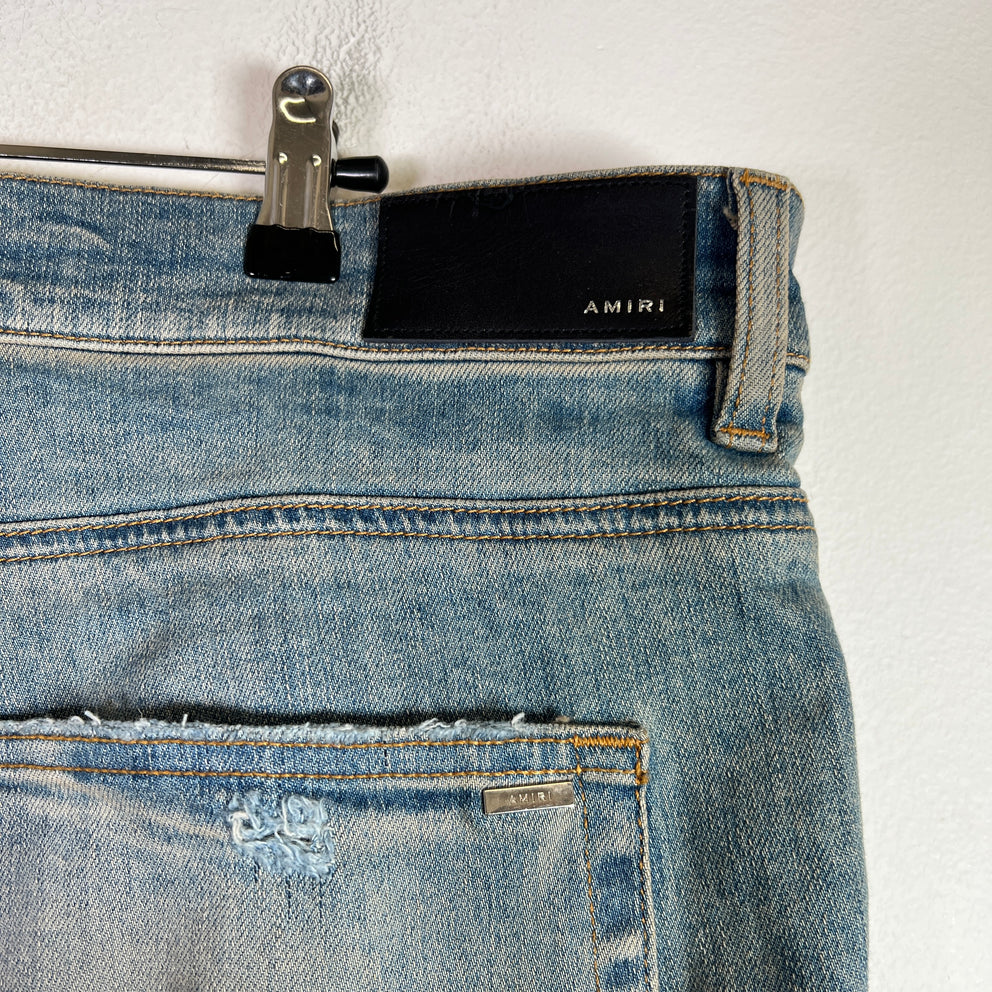 Amiri Light Indigo MX1 Black Patch Denim Jeans